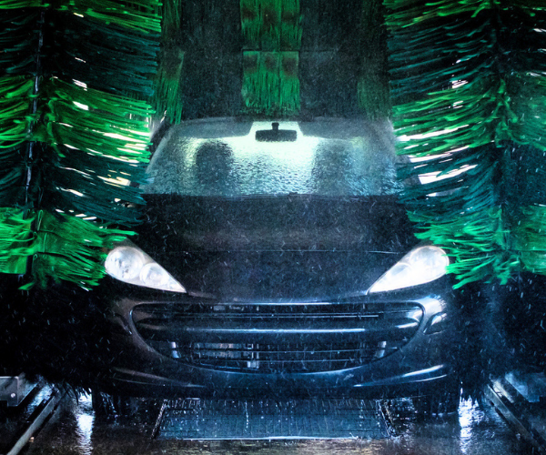 blue car going through an auto car wash