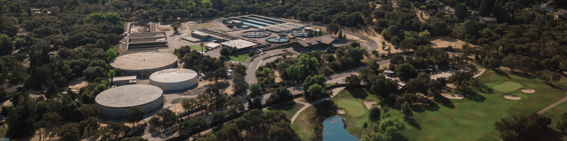 Aerial view of Barton Road Water Treatment Plant in Roseville, showing treatment basins, storage tanks, and surrounding neighborhoods near Folsom Lake.