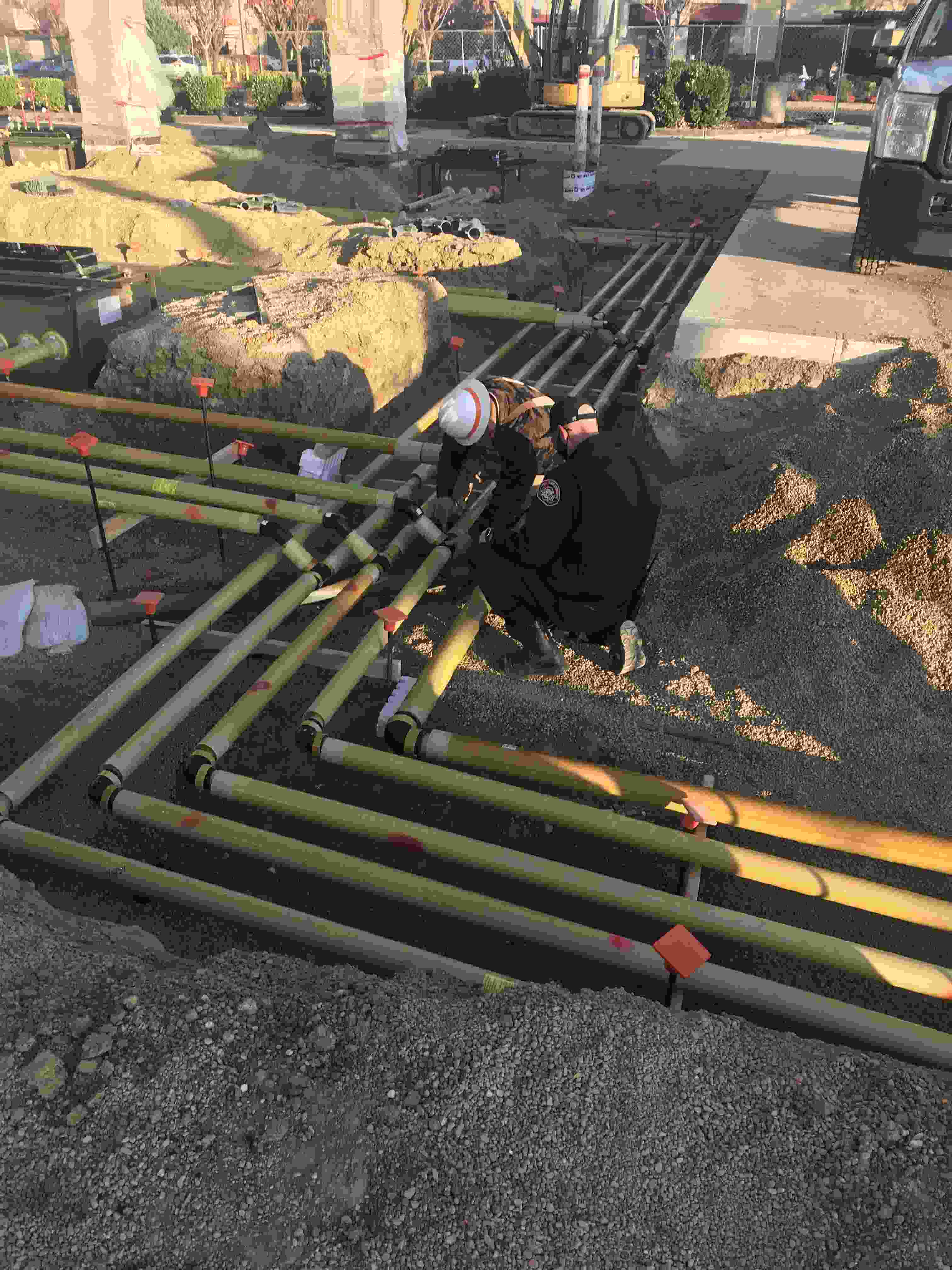 inspectors looking at underground pipes 