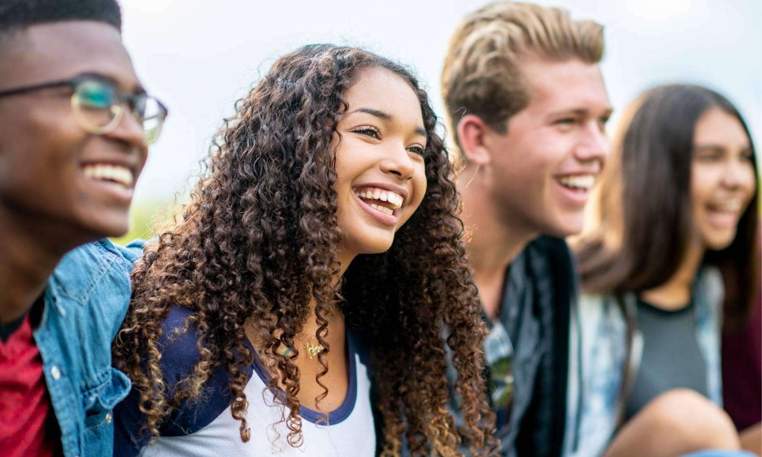 Teens smiling and looking away from the camera