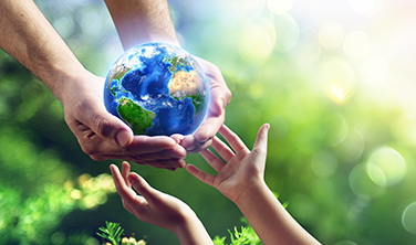 Image of hands with one holding a globe