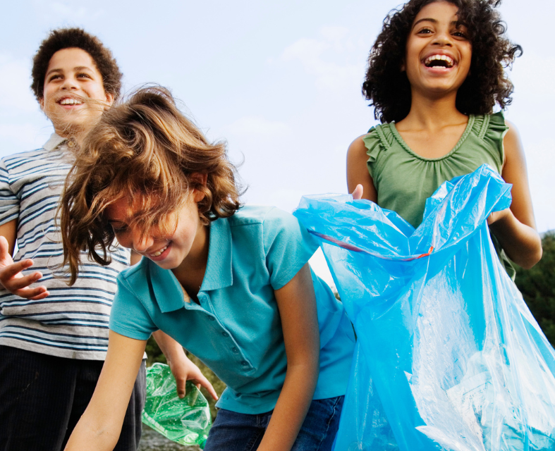 Smiling kids with trash items