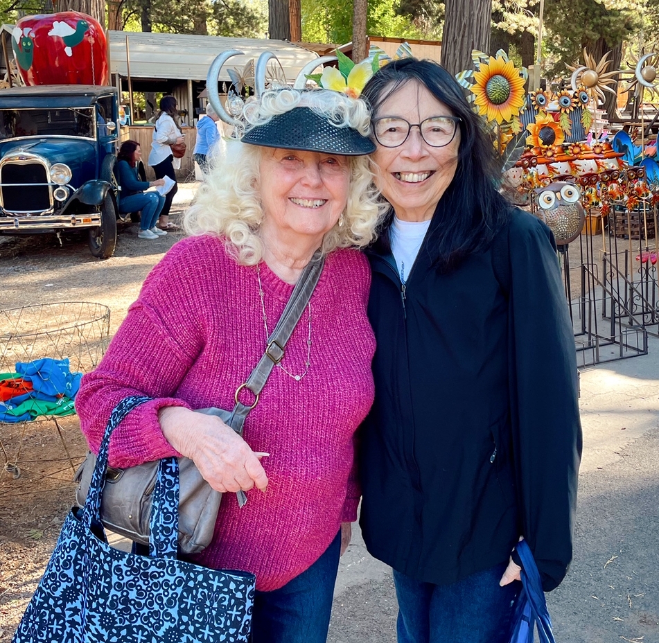 Two women standing side by side smiling